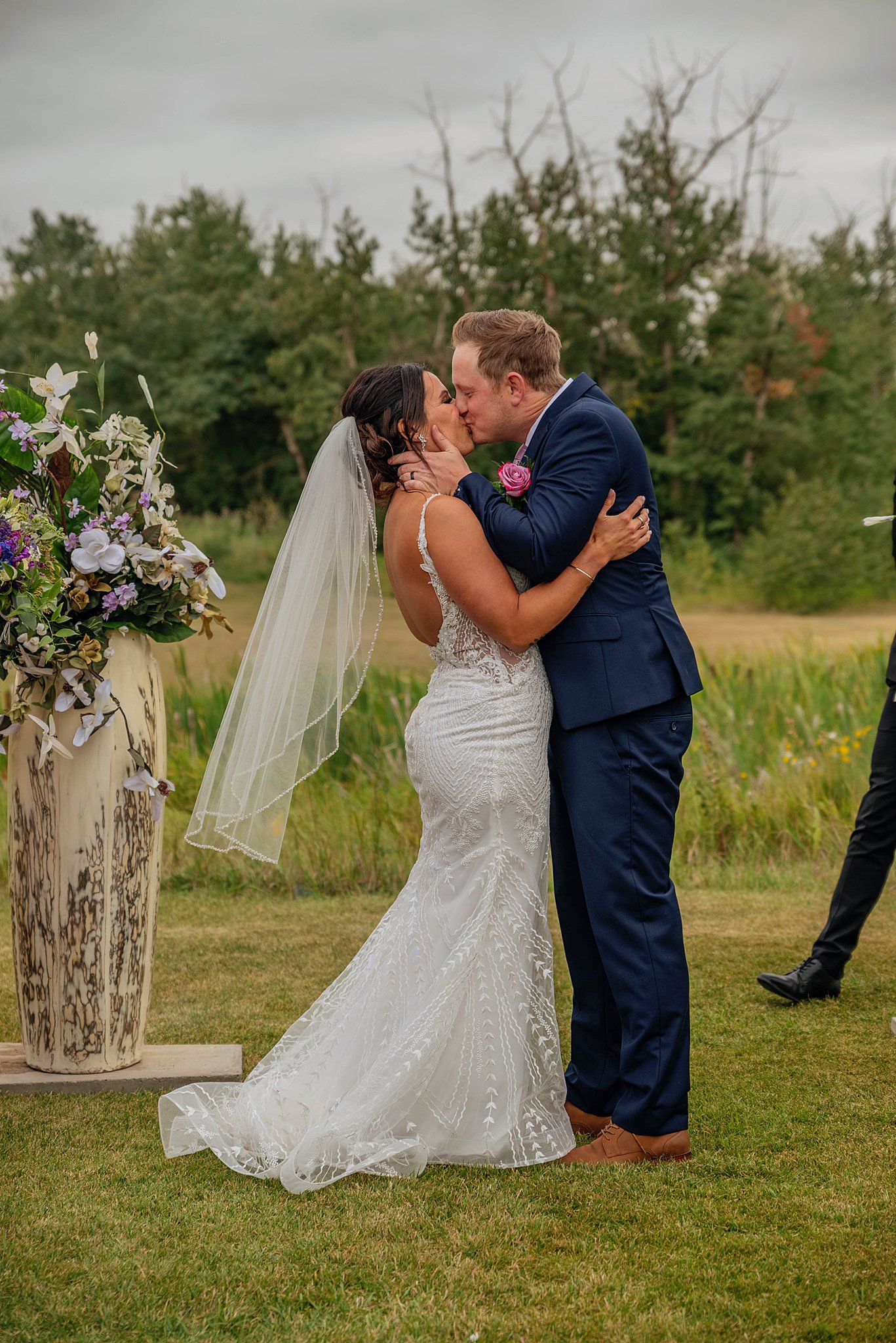 bride and groom sharing their first kiss Edmonton Golf Course Wedding Venues