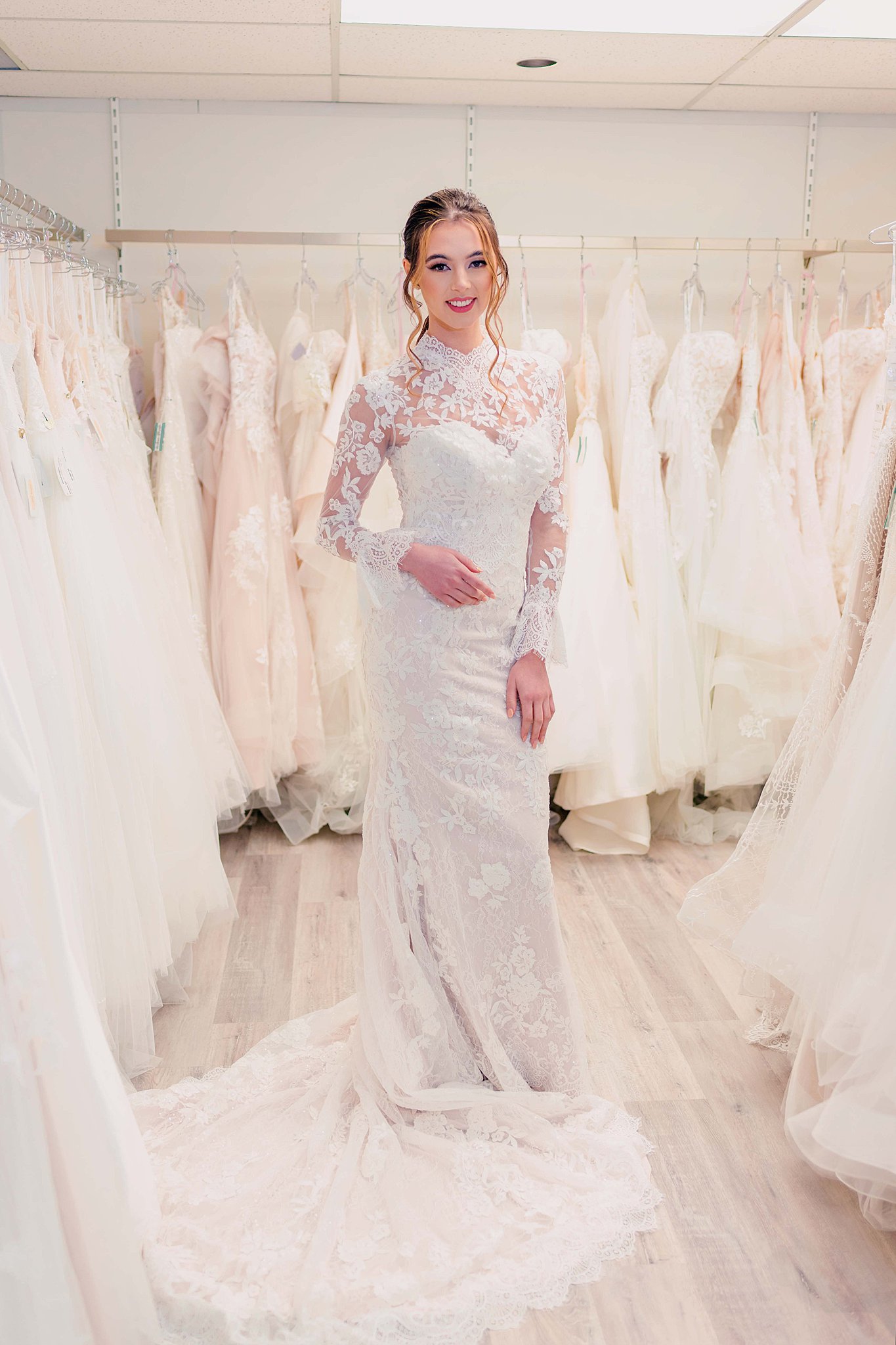 bride wearing a long sleeved lace gown from Edmonton Wedding Dress Consignment