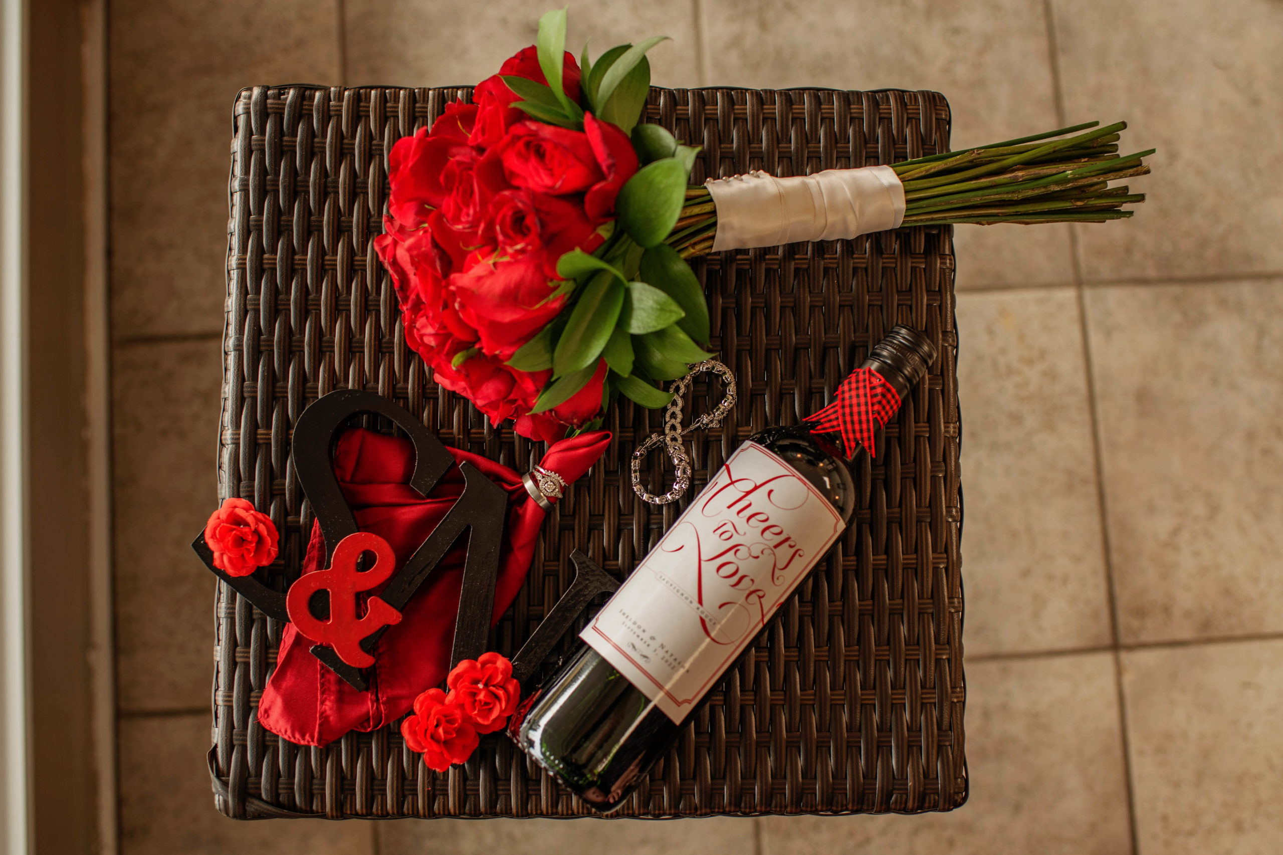 wine and red roses on a table
