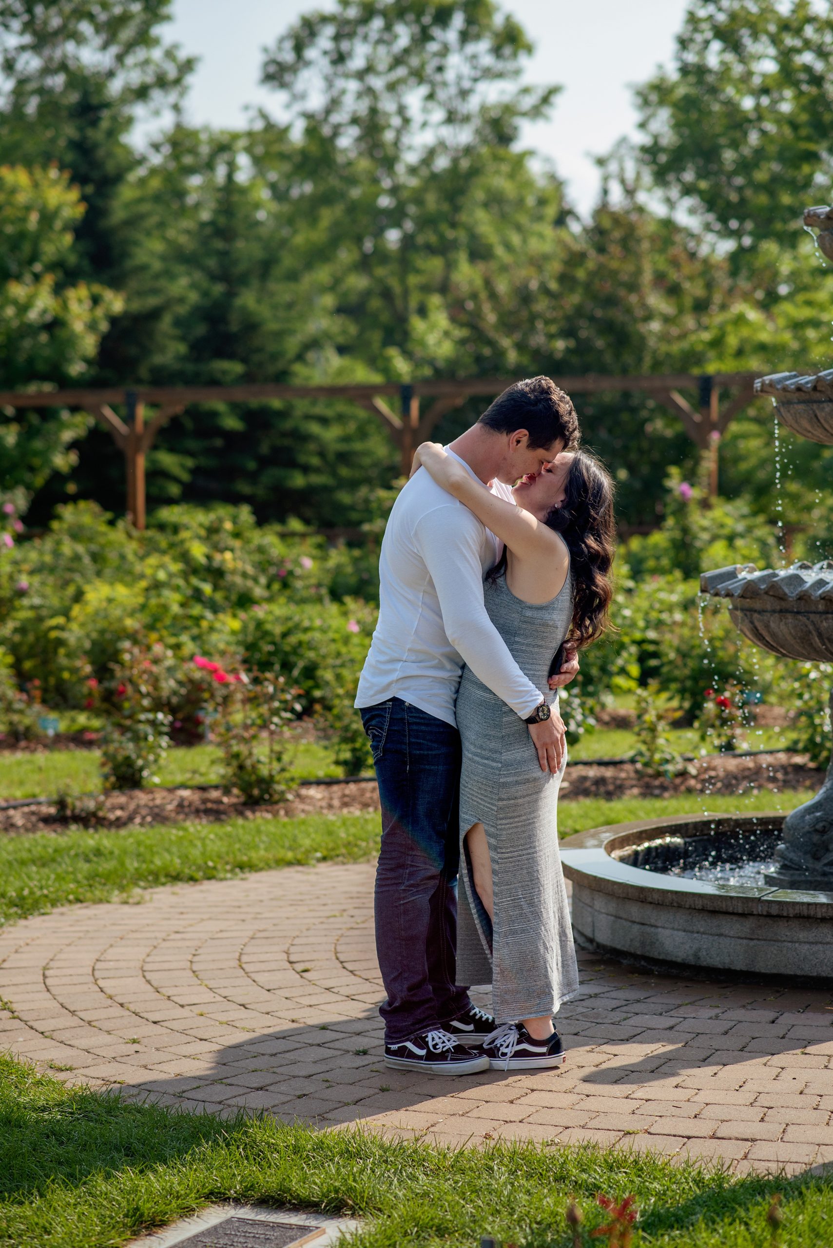 couple kissing near a fountain in St. Albert Botanical Garden