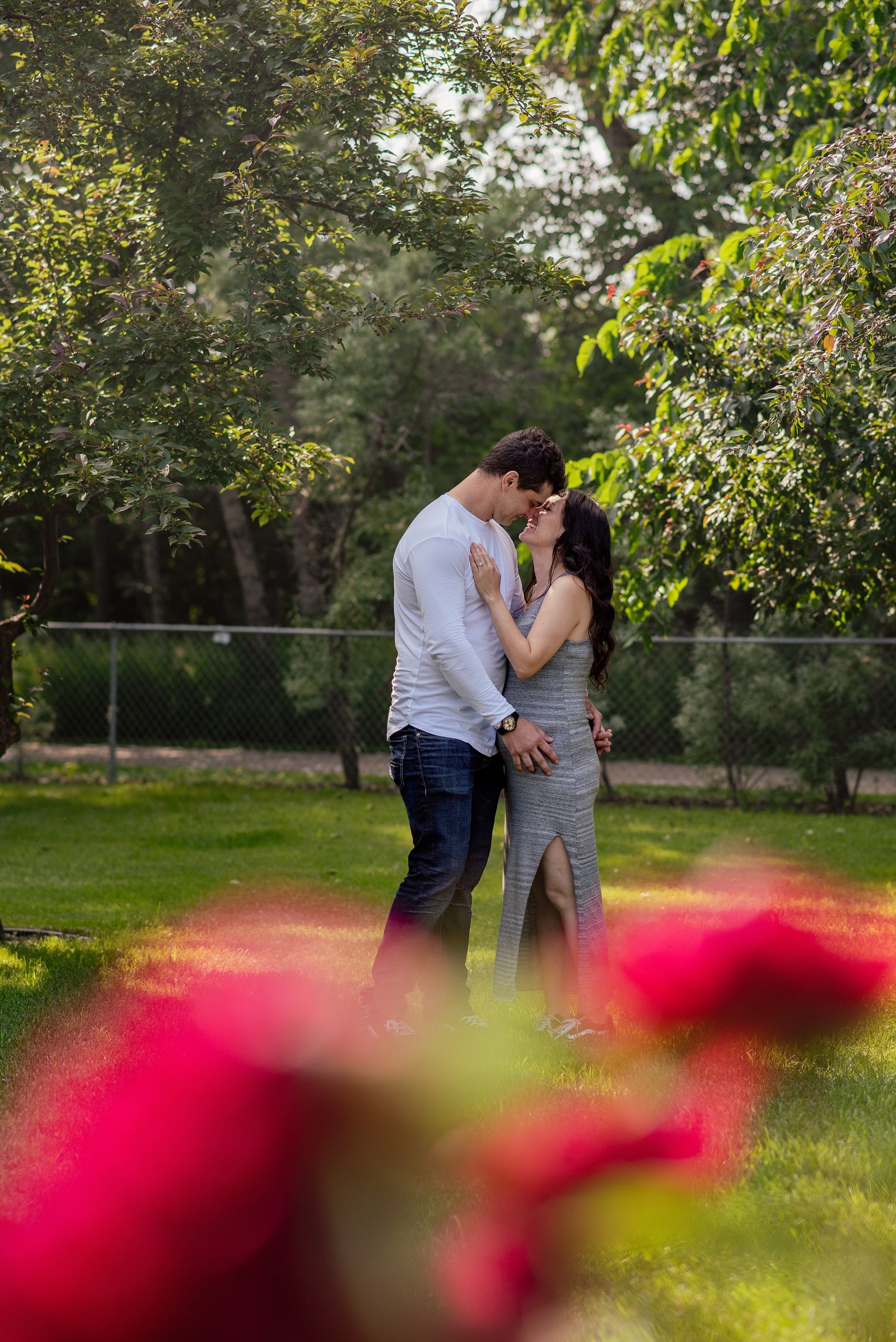man and woman kissing after getting engaged at St. Albert Botanical Garden
